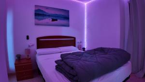 a bedroom with a bed with lights on it at Apartalux Magic Paradise in Oropesa del Mar