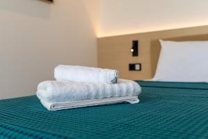 a stack of towels sitting on top of a bed at Villa Rosemary in Xiropigado +47 photos