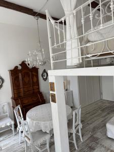 a dining room with a bed and a table and chairs at Maison Menton in Menton