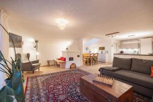 a living room with a couch and a table at Katja's Loft in Neustift im Stubaital