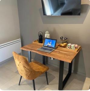 a laptop computer sitting on a wooden desk with a chair at Château Gombert in Marseille +6 photos