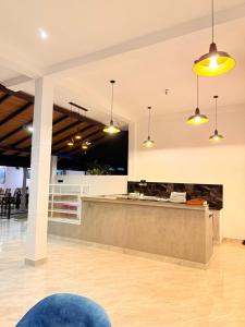 a lobby with a counter and pendant lights at Rainforest Mount Lodge in Deniyaya