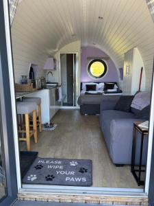 a living room with a couch and a kitchen at Four Paws Glamping in Aberystwyth +15 photos