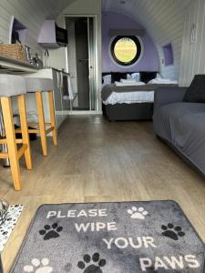 a living room with a bed and a rug at Four Paws Glamping in Aberystwyth