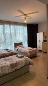 a bedroom with two beds and a ceiling fan at Nur Sena's House in Istanbul