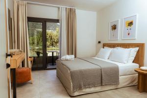 a bedroom with a bed and a sliding glass door at Villas Marajo in Skala Potamias +92 photos