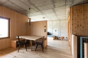 a room with a table and chairs and a bedroom at Füchslhof in Marlengo