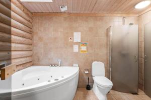 a bathroom with a white tub and a toilet at HA398-Saeby-Kulmulevej-9 in Lyngså