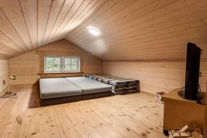 a room with two beds and a tv in a wooden room at HA398-Saeby-Kulmulevej-9 in Lyngså