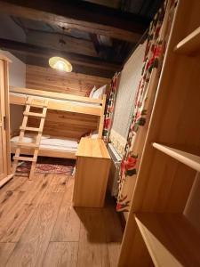 a small room with two bunk beds and a desk at Leśna 6 in Sierakowo