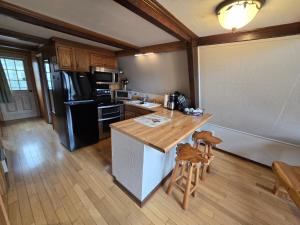 a kitchen with a wooden counter top and a refrigerator at Roaring Fork Chalet in Burnsville