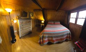 a bedroom with a bed and a dresser in a room at Roaring Fork Chalet in Burnsville