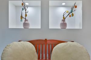 two vases with flowers in them on a wall at Hiddenhill Bulkuksa Hotel in Gyeongju