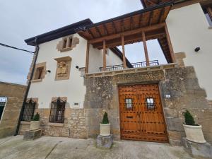 a building with a wooden door in front of it at CASA URRA in Zurucáin