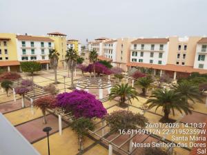 a view of a courtyard with trees and purple flowers at Mb HOUSE VILA VERDE RESORT in Prainha