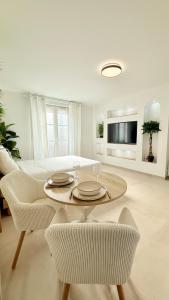 a white living room with a table and a couch at Casa Bali centre ville in Brie-Comte-Robert +7 photos
