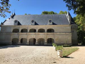 a large stone building with a gray roof at La Maison Glycine in La Villedieu