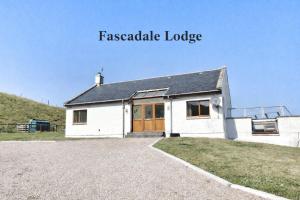 a white house on a hill with the words feasible lodge at Fascadale in Faskadale +3 photos