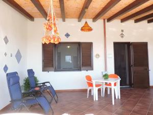 a living room with a table and chairs at Casa Alicudi in Lipari +27 photos