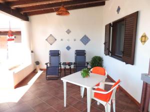 a patio with a white table and chairs at Casa Alicudi in Lipari