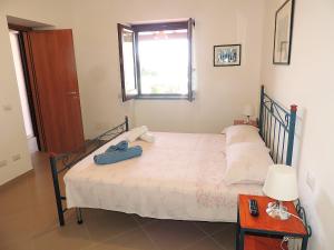 a bedroom with a bed with a suitcase on it at Casa Alicudi in Lipari