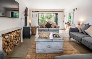 a living room with two couches and a fireplace at Blackshore House in Wenhaston