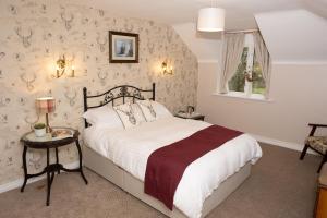 a bedroom with a large bed and a window at Dromard House in Enniskillen