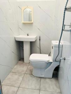 a bathroom with a toilet and a sink at Sirisewana Holiday Inn in Ja-Ela