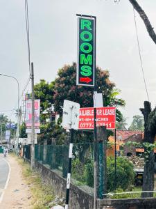 a group of signs on the side of a road at Sirisewana Holiday Inn in Ja-Ela