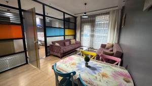 a room with a table and chairs and a living room at Nur Sena's House in Istanbul