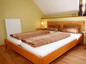 a bedroom with a large bed in a room at Winzerhof Weber in Buggingen