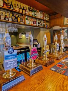 a bar with bottles of alcohol on top of it at The Lower Buck Inn in Clitheroe