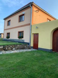 a house with a grass yard in front of it at Apartmans ZBYTINY 21 in Zbytiny