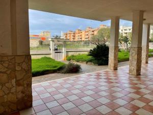 a view of a building with a tile floor and columns at Dimora Letizia in Gallipoli