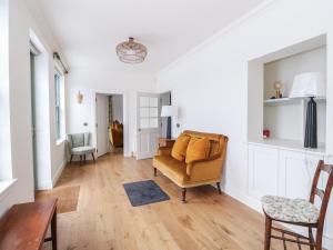 a living room with a chair and a couch at Schiehallion House in Pitlochry