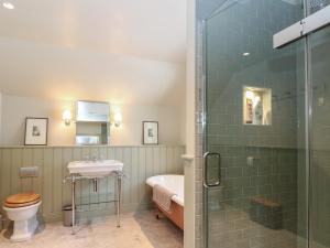 a bathroom with a shower and a toilet and a sink at Schiehallion House in Pitlochry +90 photos