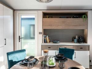a kitchen with a table and two chairs and a table at Jackson Lodge - Primrose in Malton