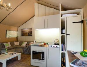 a kitchen and living room in a tiny house at Blencathra - Safari Tent in Ambleside