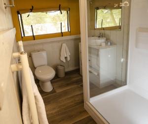 a small bathroom with a toilet and a sink at Blencathra - Safari Tent in Ambleside