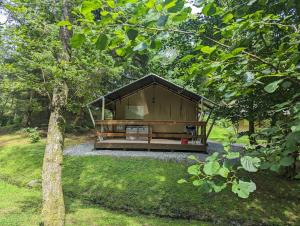 a large wooden building in the middle of a yard at Blencathra - Safari Tent in Ambleside