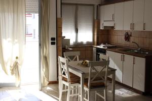 a kitchen with a table and chairs and a sink at Situation House in Catanzaro Lido +17 photos