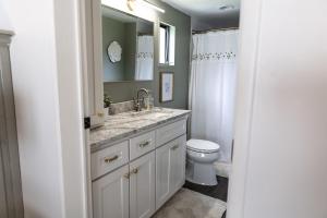 a bathroom with a sink and a toilet at The Cottage at Cardinal Hill in Dahlonega +14 photos