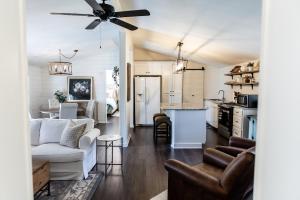 a living room and kitchen with a ceiling fan at The Cottage at Cardinal Hill in Dahlonega