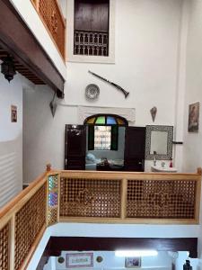 a room with a wooden staircase and a window at DarMouniaFès in Fez