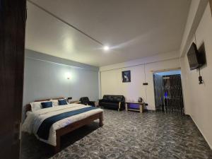 a hotel room with a bed and a couch at Eyana Residency in Lāitlyngkot