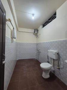 a bathroom with a white toilet in a room at Eyana Residency in Lāitlyngkot +2 photos