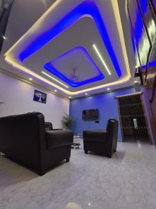 a living room with blue lights on the ceiling at Eyana Residency in Lāitlyngkot
