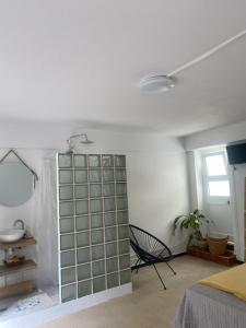 a bedroom with a glass door in the middle of a room at Quarto, Algarve in Olhão +22 photos