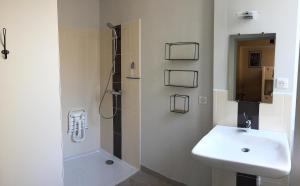 a bathroom with a sink and a shower and a toilet at Auberge de Treigny - Les chambres in Treigny