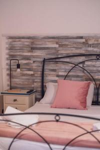 a bedroom with a bed with a wooden headboard at Sassari Station Inn in Sassari
